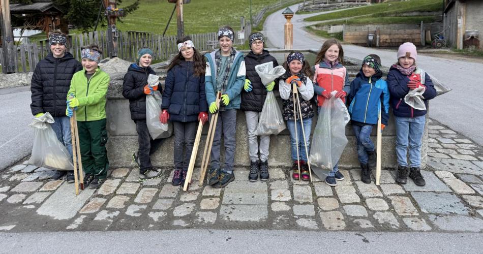 Kinder mit Müllzangen und Müllsäcken